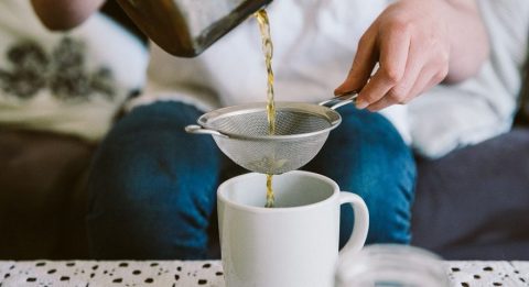 pouring tea through tea strainer