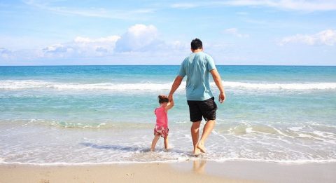 man and child at the beach