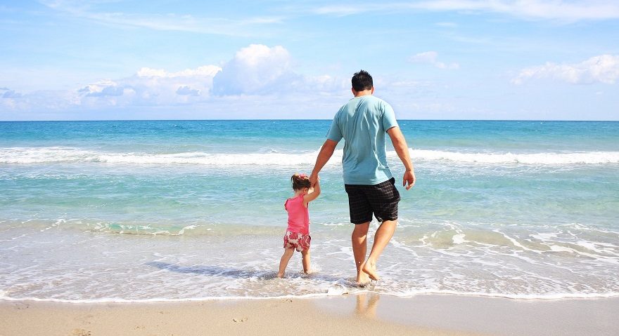 man and child at the beach